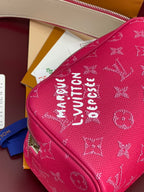Pink monogram toiletry bag close-up of large white monogram on front