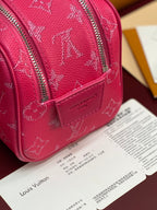Pink monogram toiletry bag close-up with front strap and vertical zip