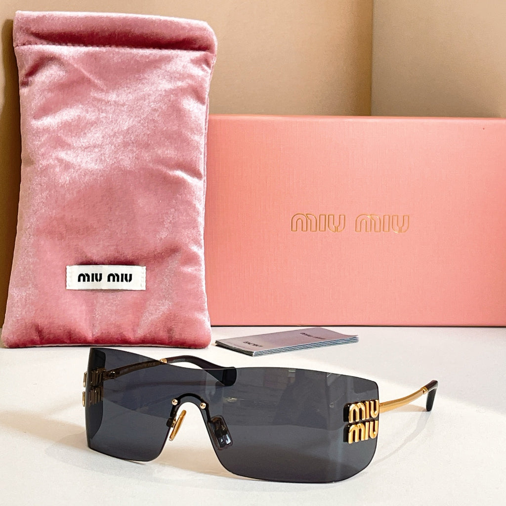 Miu Miu glasses with gold-tone frame and dark gray tinted lenses