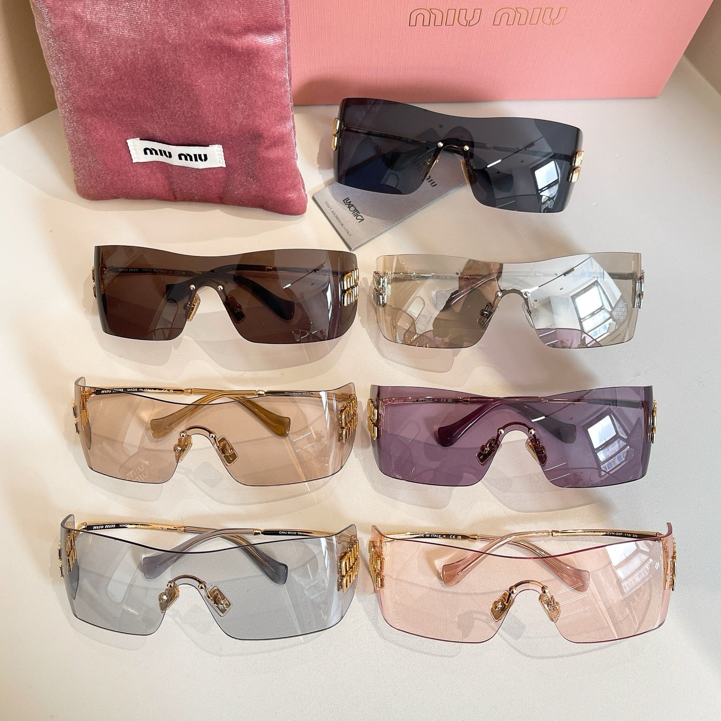 Set of Miu Miu glasses with various colored lenses arranged on display