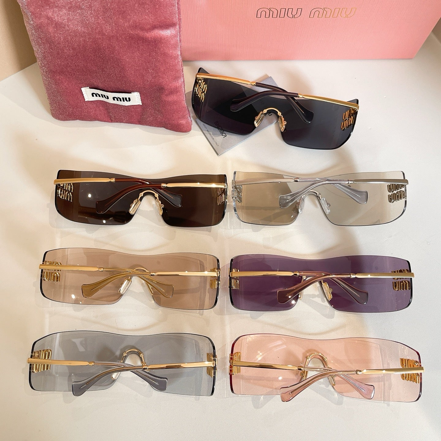 Set of Miu Miu glasses with mixed dark and clear lenses arranged in rows