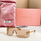 Miu Miu glasses with gold-tone frame and clear lenses
