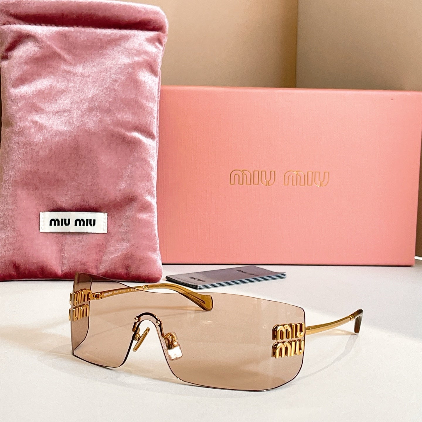 Miu Miu glasses with gold-tone frame and clear lenses