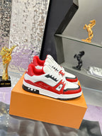 White and red Louis Vuitton sneakers with black trim, lace-up design, and LV emblem
