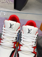 Close-up of white Louis Vuitton sneakers with red lining, lace-up, and LV logo on tongue