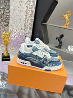 Louis Vuitton ladies sneakers, side view with blue pattern, white laces and rubber sole