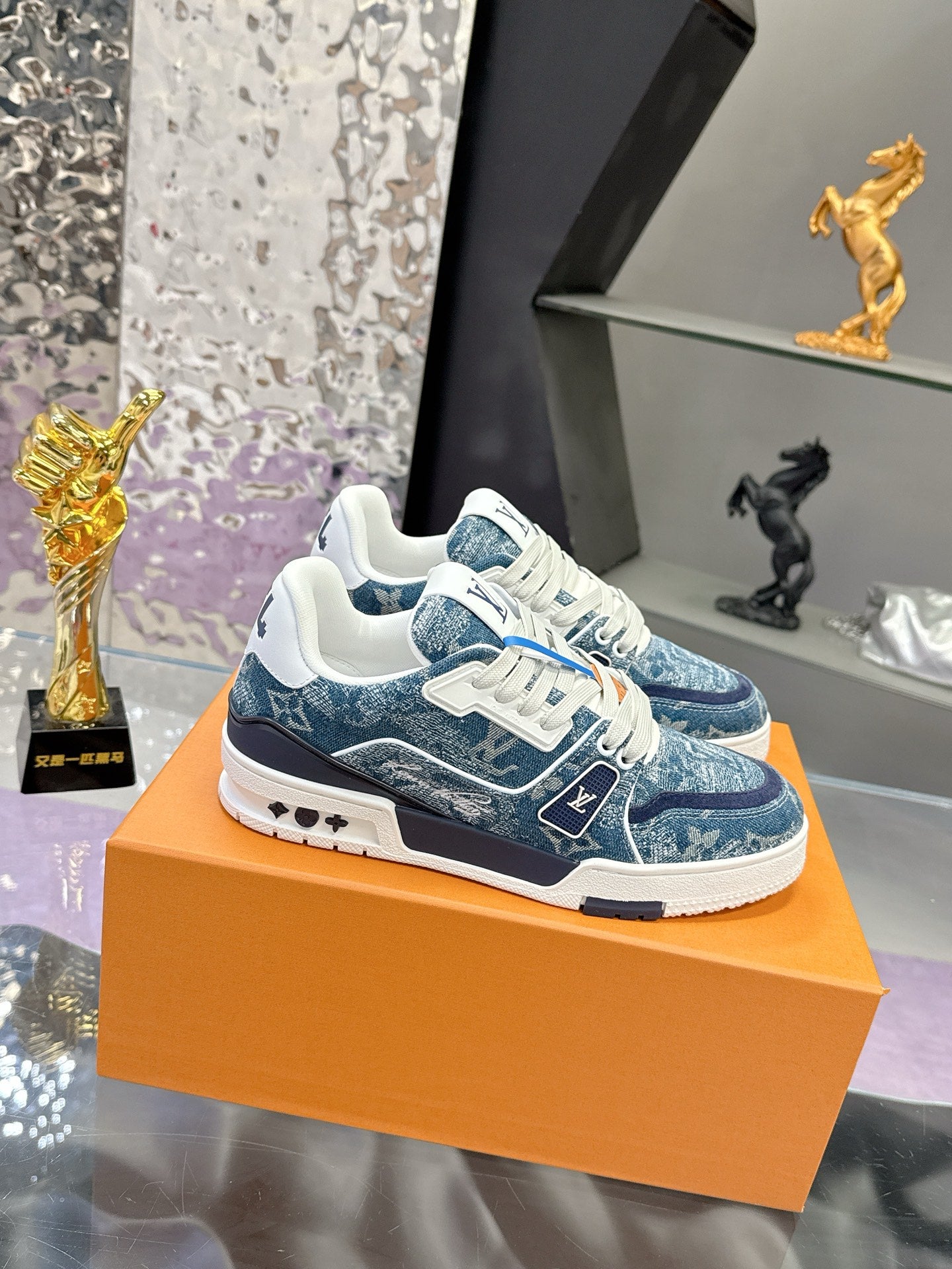 Louis Vuitton ladies sneakers, side view with blue pattern, white laces and rubber sole