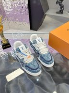 Louis Vuitton ladies sneakers, front angled view with blue patterned uppers and white laces