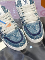 Louis Vuitton ladies sneakers close-up, blue patterned toe and side panels, white laces
