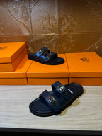 Hermes blue slide sandals with two front buckles, three-quarter view