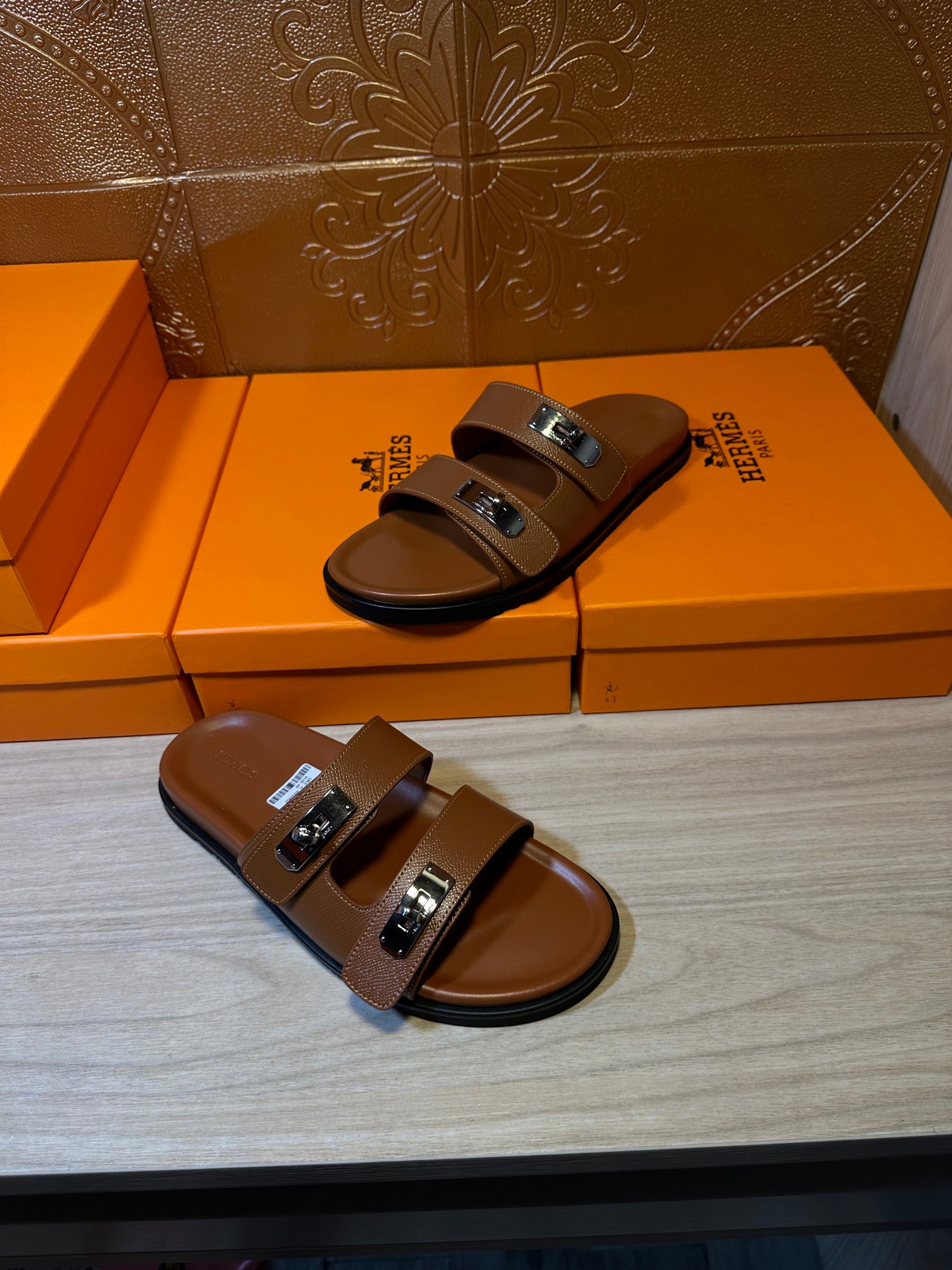 Tan leather slide sandals with silver buckles and two strap bands