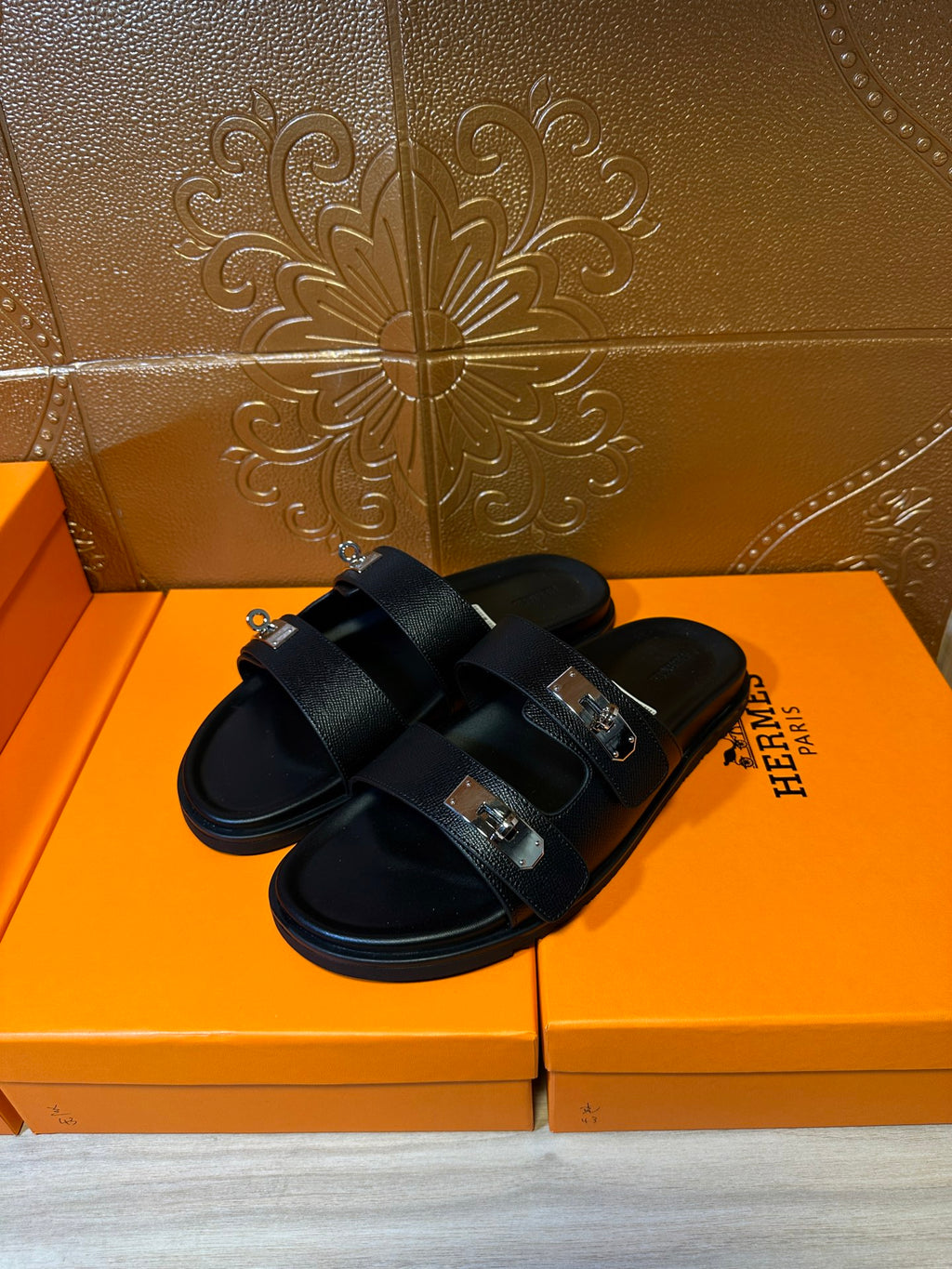 Hermes black leather sandals, side view with adjustable buckle straps