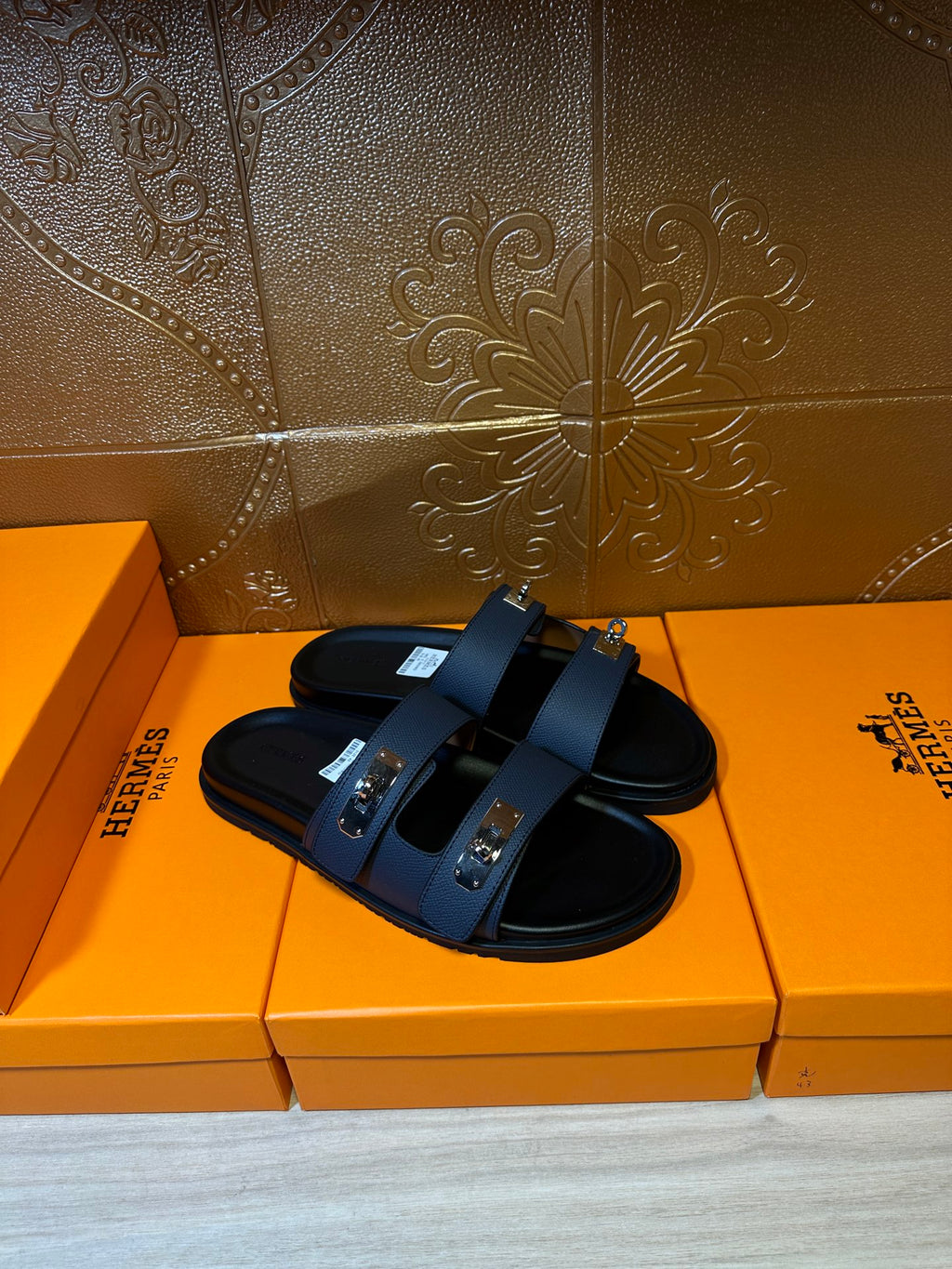 Hermes blue slide sandals with black footbed and silver-tone buckle details