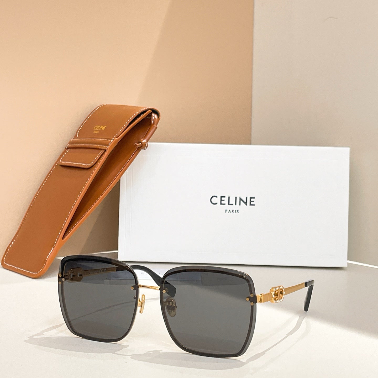 Celine glasses with dark frames and smoked lenses, gold-tone accents and arms