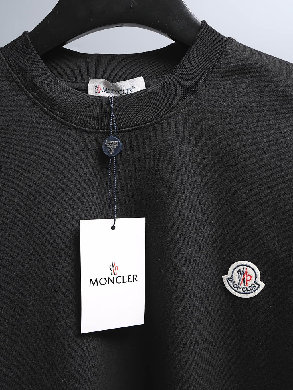 Moncler black short-sleeve T-shirt with crew neck and hanging brand tag