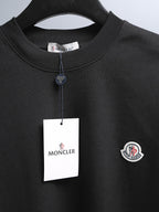 Moncler black short-sleeve T-shirt with crew neck and hanging brand tag