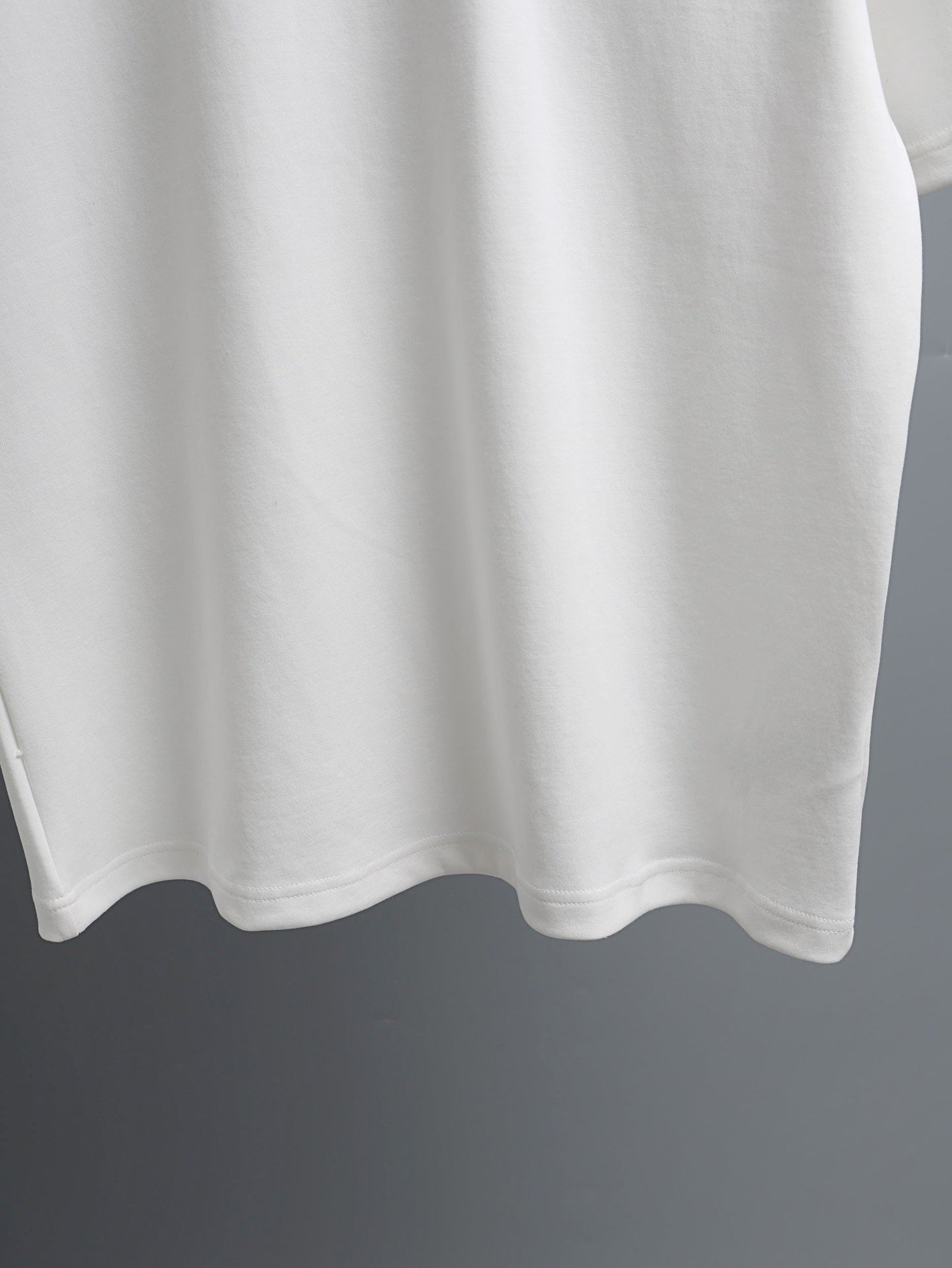 White T-shirt hem with curved bottom edge