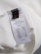 White T-shirt fabric label with size and care details, tag at inside seam