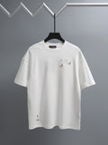 White crewneck T-shirt with embroidered multicolor bird graphics on the chest