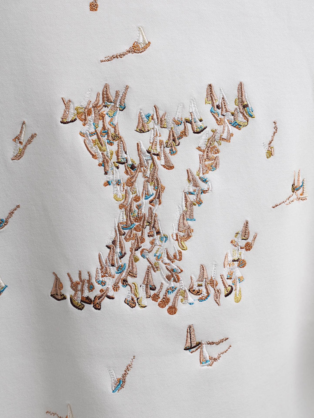 White T-shirt with dense multicolor embroidered bird pattern across the chest