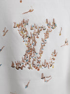 White T-shirt with dense multicolor embroidered bird pattern across the chest