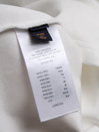 White shorts fabric label with Louis Vuitton branding and size details