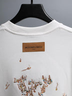 White crewneck T-shirt with brown brand neck label and embroidered bird graphic