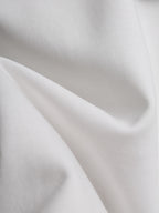 White T-shirt fabric close-up with soft drape and visible knit texture