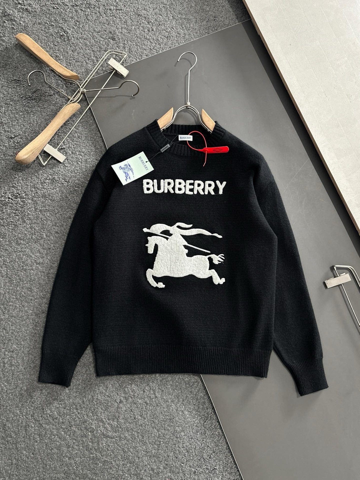 Black knit sweater with BURBERRY logo and white horse graphic on chest