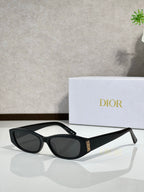 Black sunglasses with dark lenses and gold detail on temple