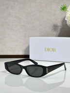 Black cat-eye sunglasses with dark lenses and gold temple accent