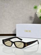 Black eyeglasses with light lenses and gold temple detail