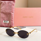MiuMiu oval sunglasses with gold-tone frame and dark black gradient lenses