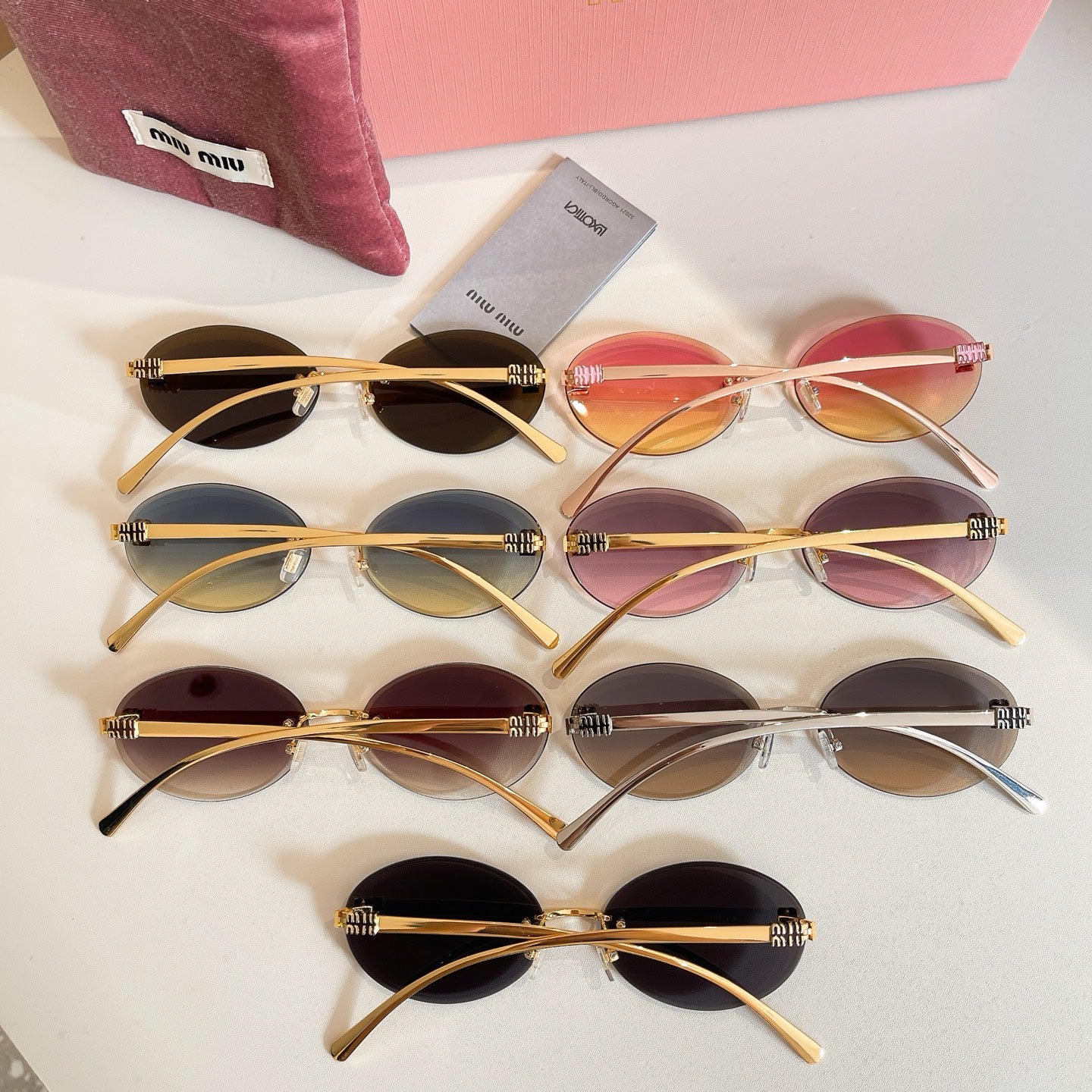 Set of MiuMiu oval sunglasses with gold-tone frames and gradient lenses