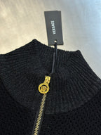 Dark ribbed sweater with gold zipper and Versace clothing tag