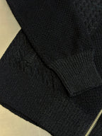 Dark knit sweater cuff and ribbed hem with gold zipper