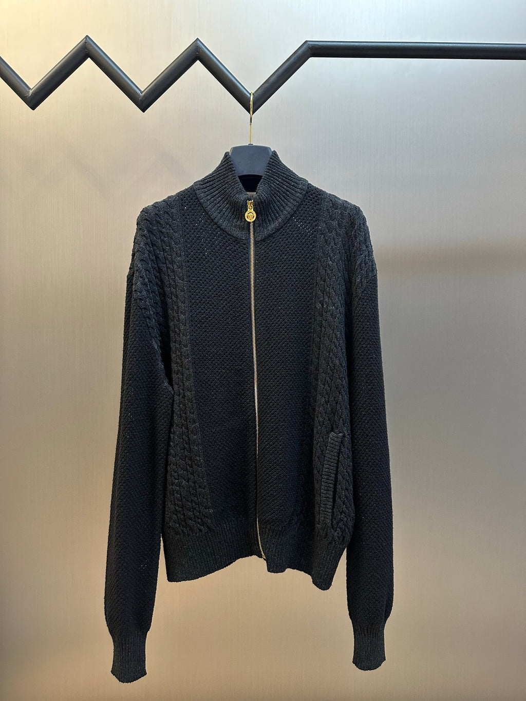 Dark knit zip-up sweater with mock neck and gold-toned zipper