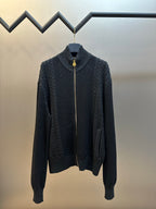 Dark knit zip-up sweater with mock neck and gold-toned zipper