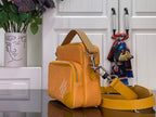 Orange monogram crossbody bag with flap front, zipper top, and gold-tone hardware