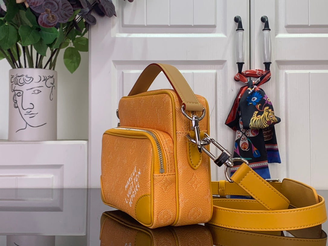 Louis Vuitton orange monogram crossbody bag with gold-tone hardware and wide strap