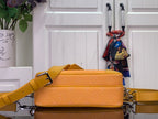 Orange monogram crossbody bag with yellow strap and stacked flap front detail
