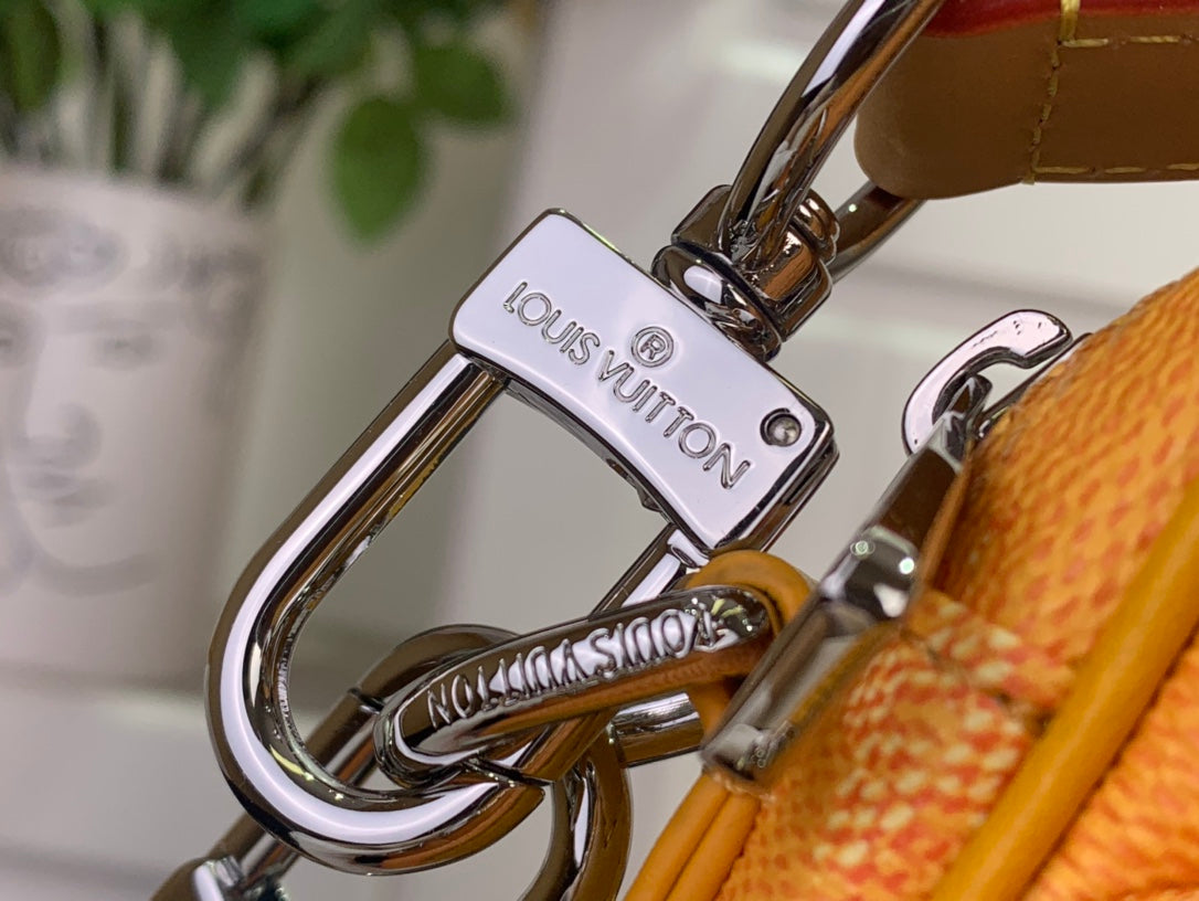 Louis Vuitton bag closure hardware with engraved logo plate and metal D-ring