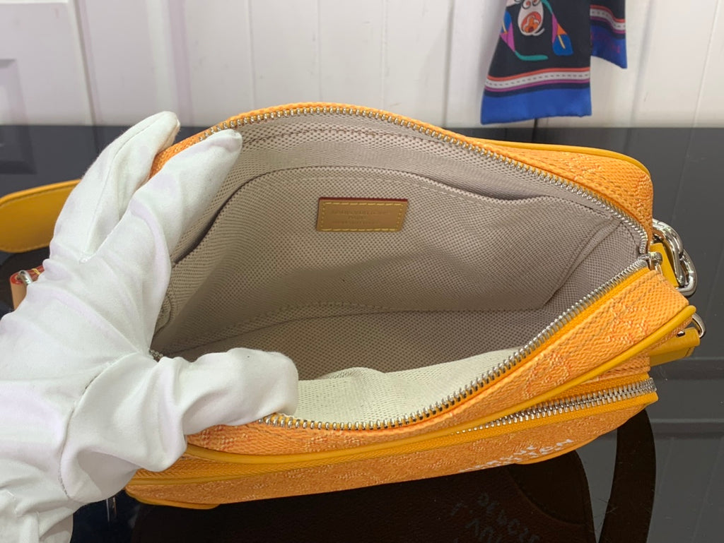 Louis Vuitton orange crossbody bag interior with zip lining and logo patch