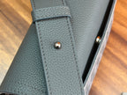Dior bag corner with stitched edge and snap button on textured leather