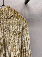 Gold-and-cream striped hooded fur jacket with dense fuzzy pile texture
