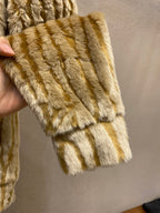 Ribbed cuff and hem of gold-and-cream striped fur jacket