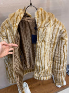Gold-and-cream striped hooded fur jacket with monogram-lined interior