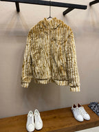 Gold-and-cream striped hooded fur jacket with ribbed cuffs and hem