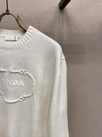 Cream knit sweater with PRADA chain logo detail at chest