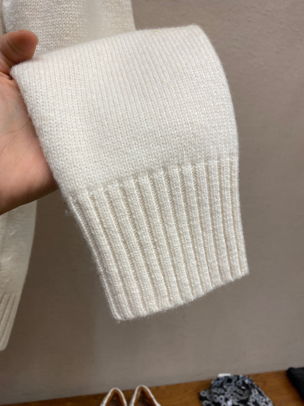 Cream ribbed knit cuff and hem detail on long sleeve sweater